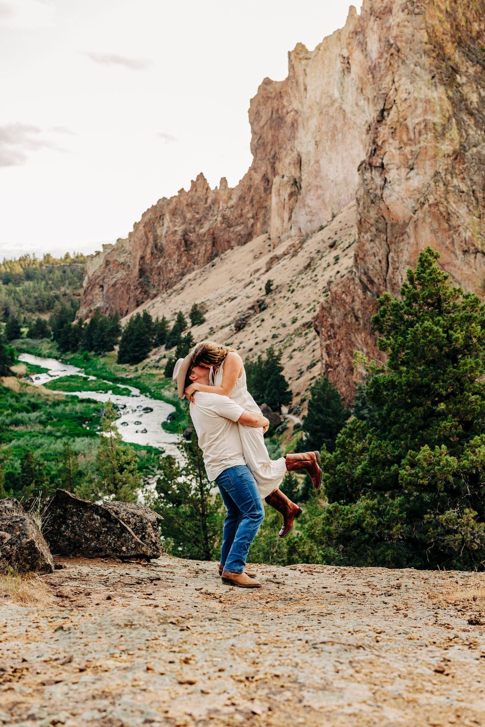 Dancing sequence captures romantic movement against stunning Smith Rock State Park cliffs and green valley.
