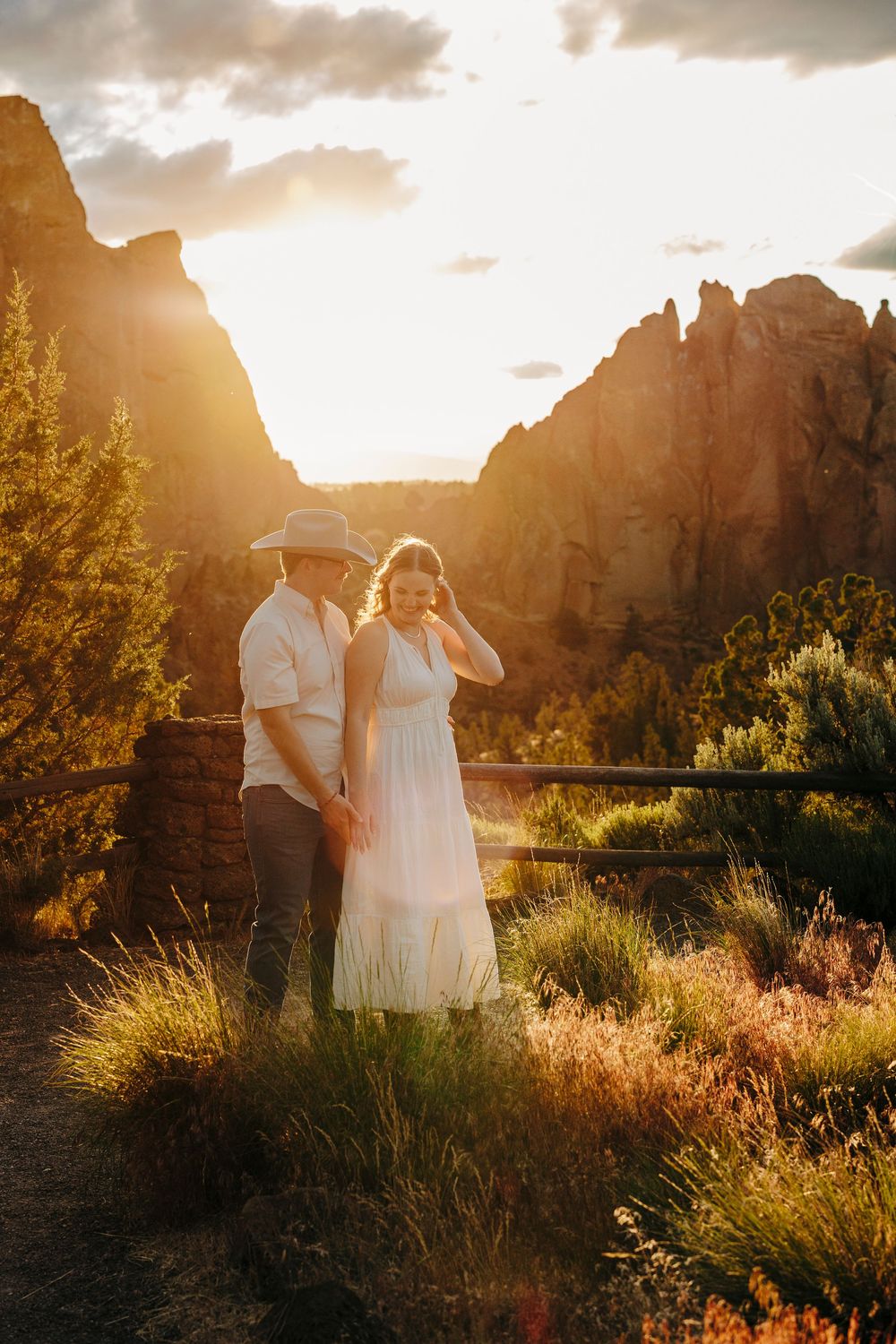 A golden hour photo session with desert rock formations and glowing sunlight.