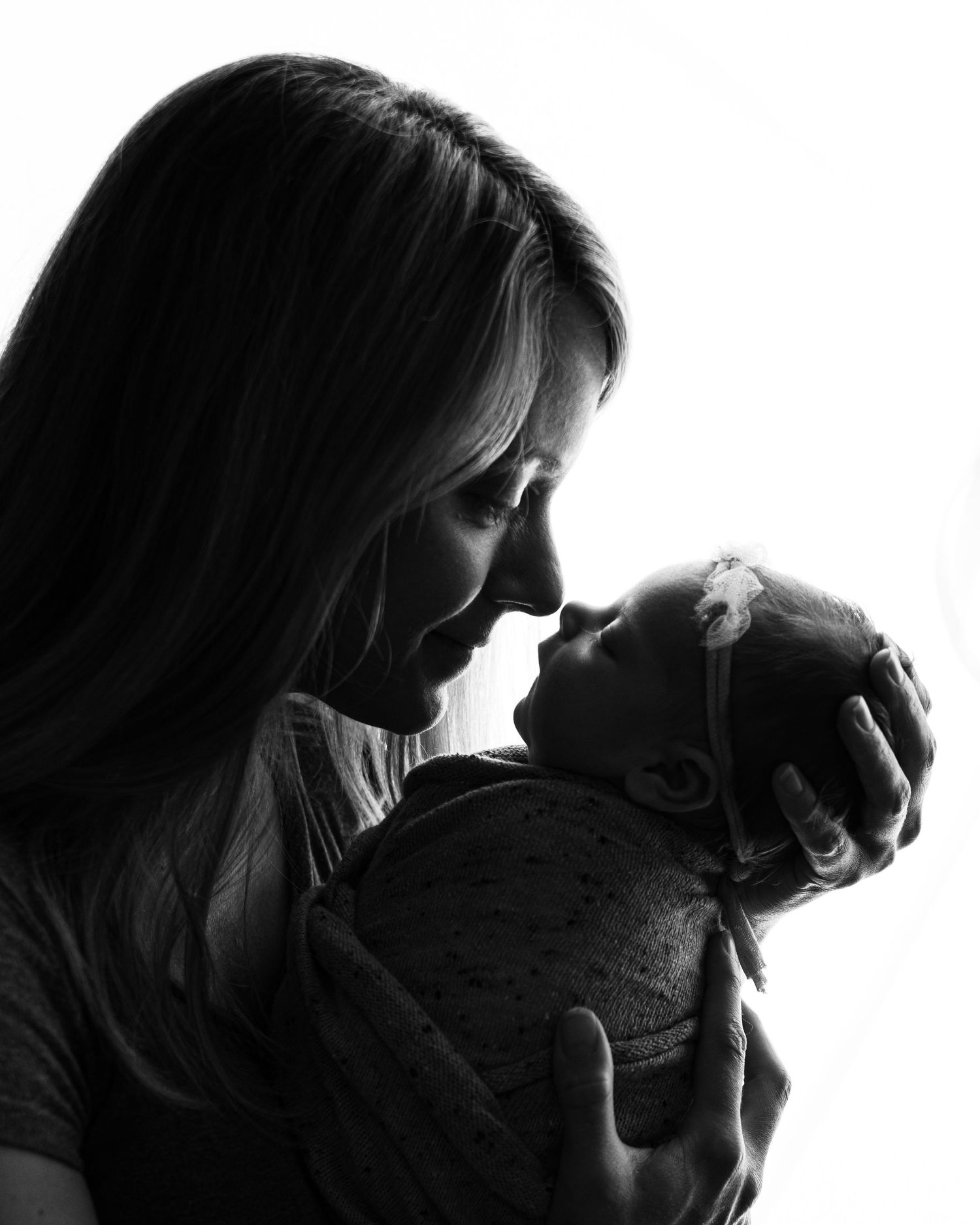 Professional black and white photo of a newborn baby and her mother