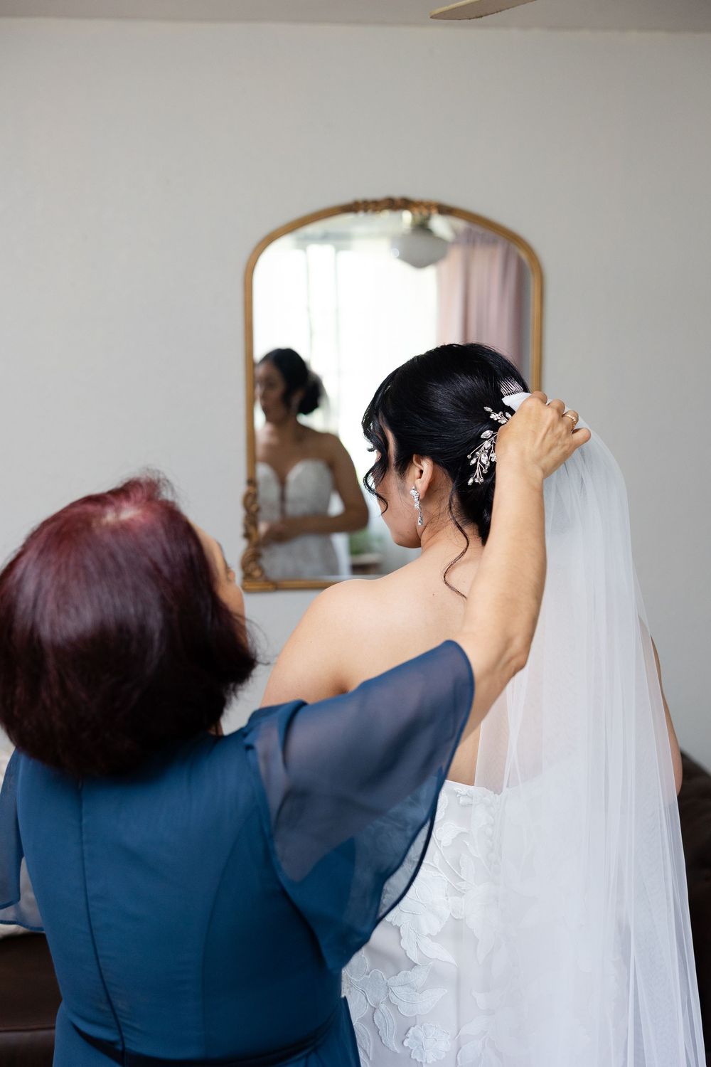 Series of shots showing someone helping adjust a bridal veil in preparation for a wedding.