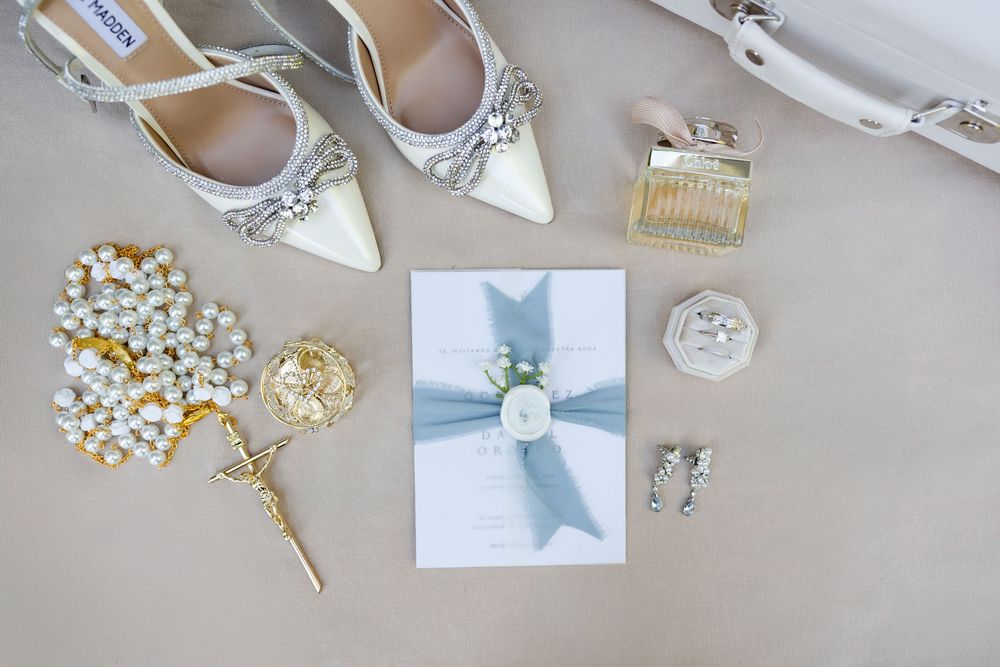 Wedding accessories including jewelry, hair pieces, and delicate white ornaments arranged on a light surface.