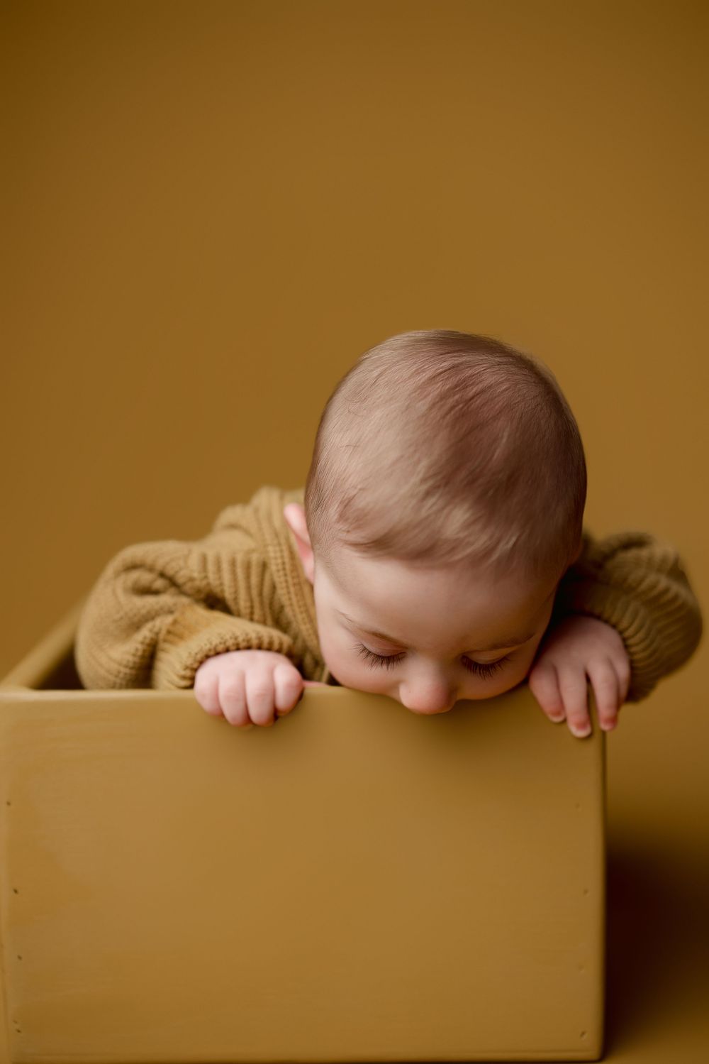 A composite photo sequence shows a baby peeking playfully over the edge of a wooden drawer.