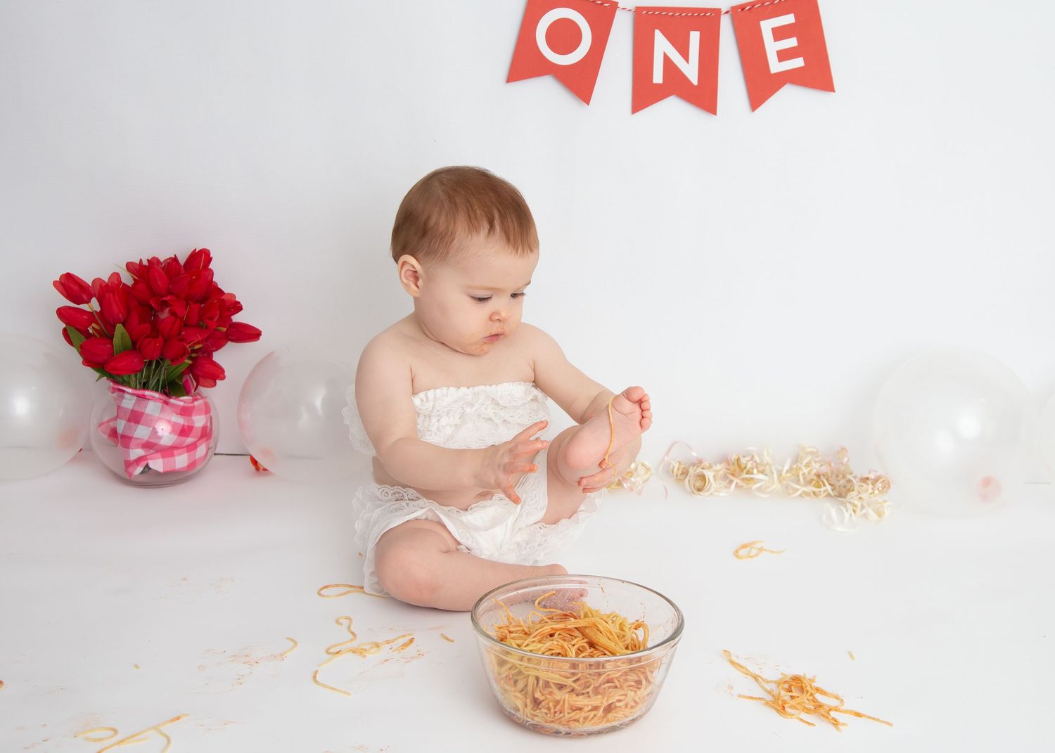 baby and spaghetti during one year photo session