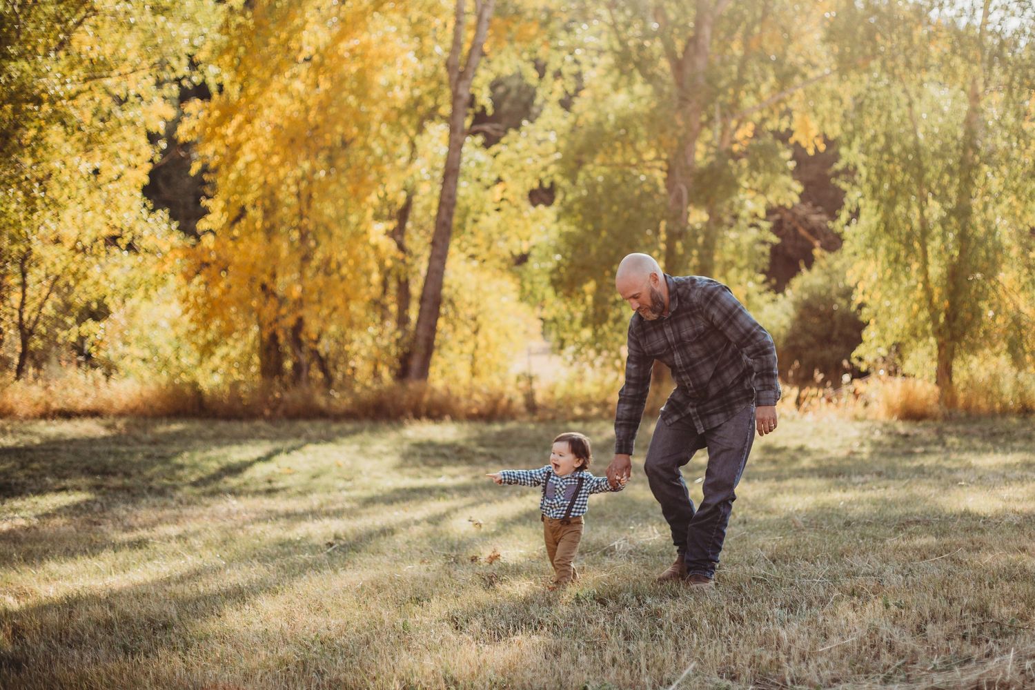 Father and son walk through the Rocky Mountains during the fall in Colorado.
