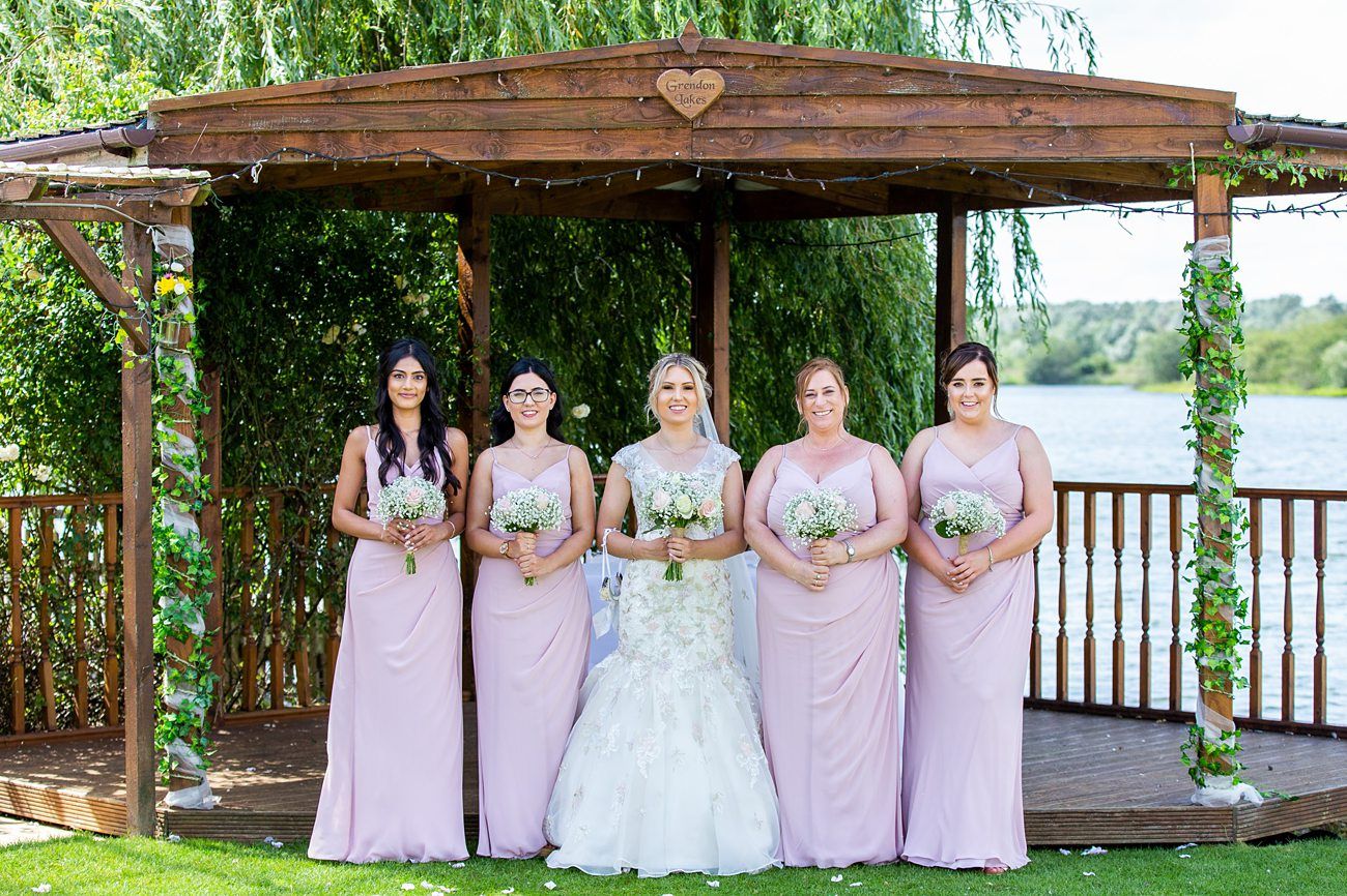 brides with bridesmaids at grendon lakes