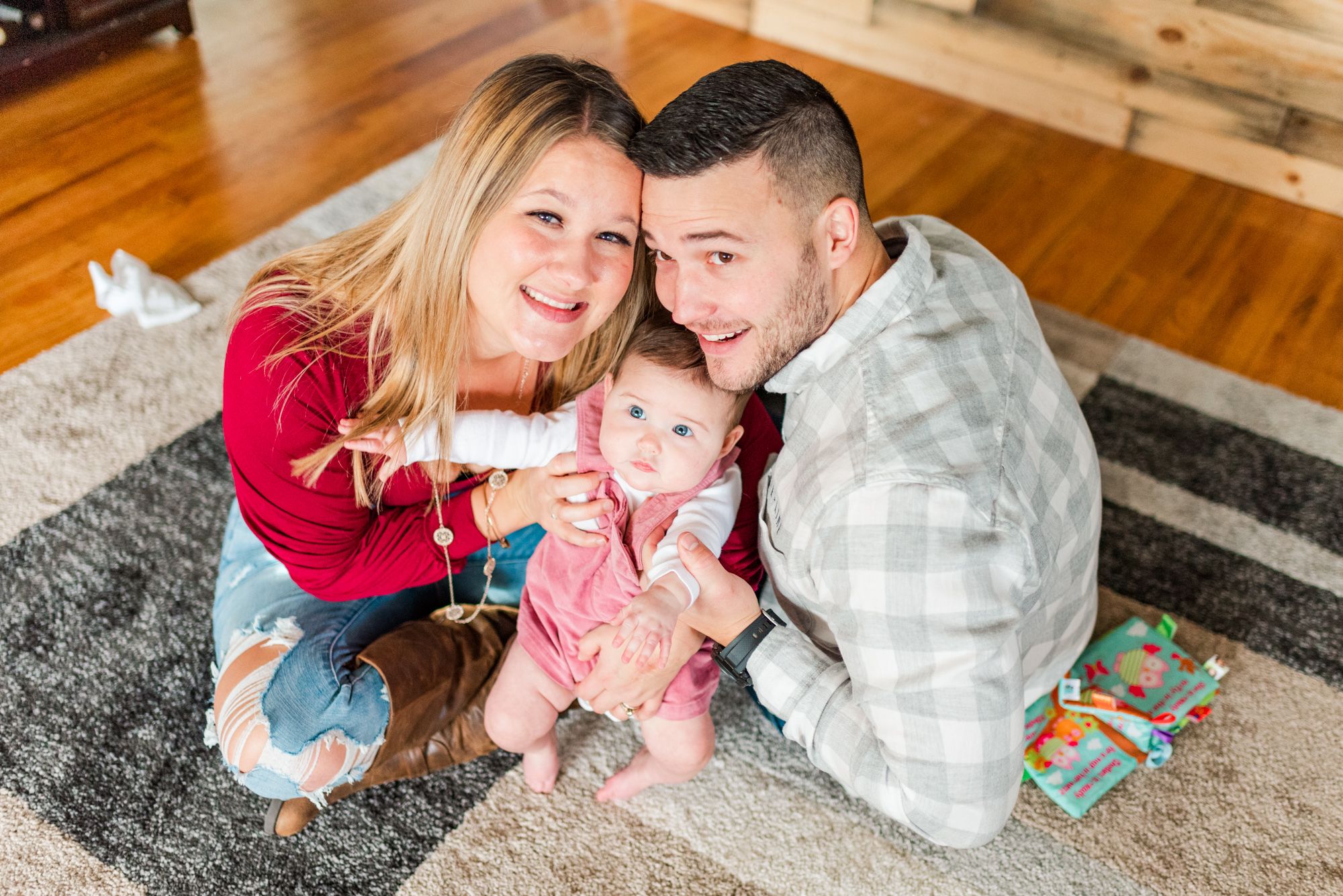 Lifestyle family photoshoot in the home with mom and dad sitting on floor with 6month old baby in Gibsonia, Pennsylvania