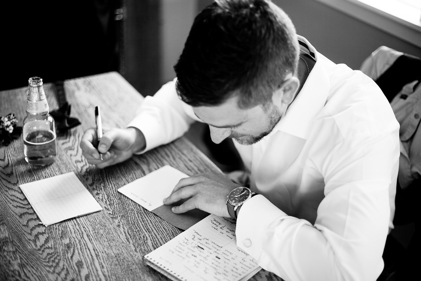 groom writing letter to bride on wedding day in Northern California