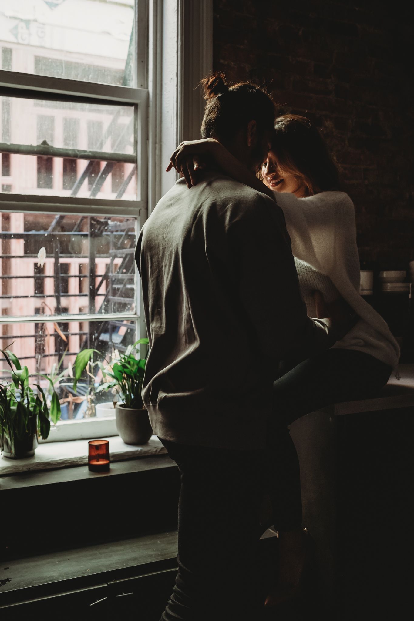 man and woman cuddle in kitchen at loft in seattle for couples photo, Issaquah, WA by Shutterbabe Snaphots