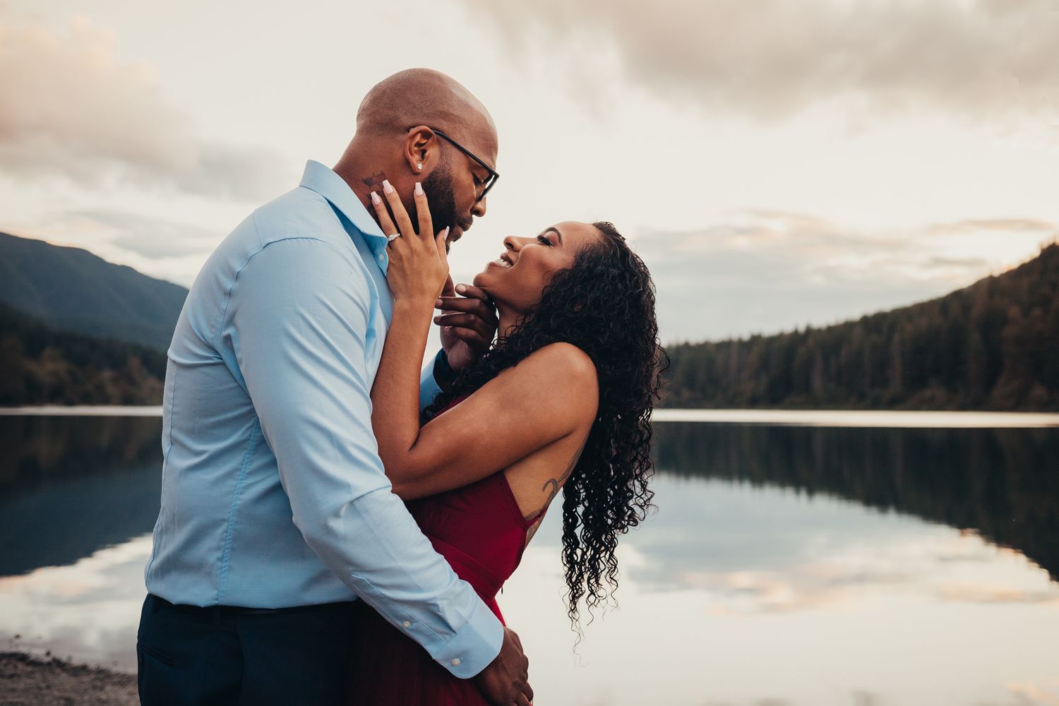 a man and woman embrace in front of rattlesnake lake for engagement photography, issaquah wa by shutterbabe snapshots