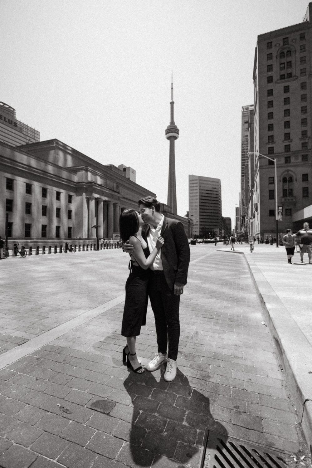 Urban romance scene in Toronto with CN Tower visible in the background