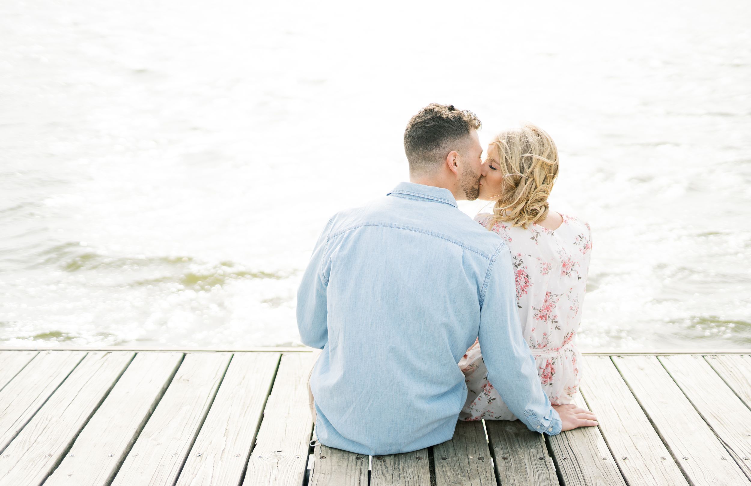 Light and airy film lakeside dock engagement session at Gray's Lake in Des Moines, Iowa