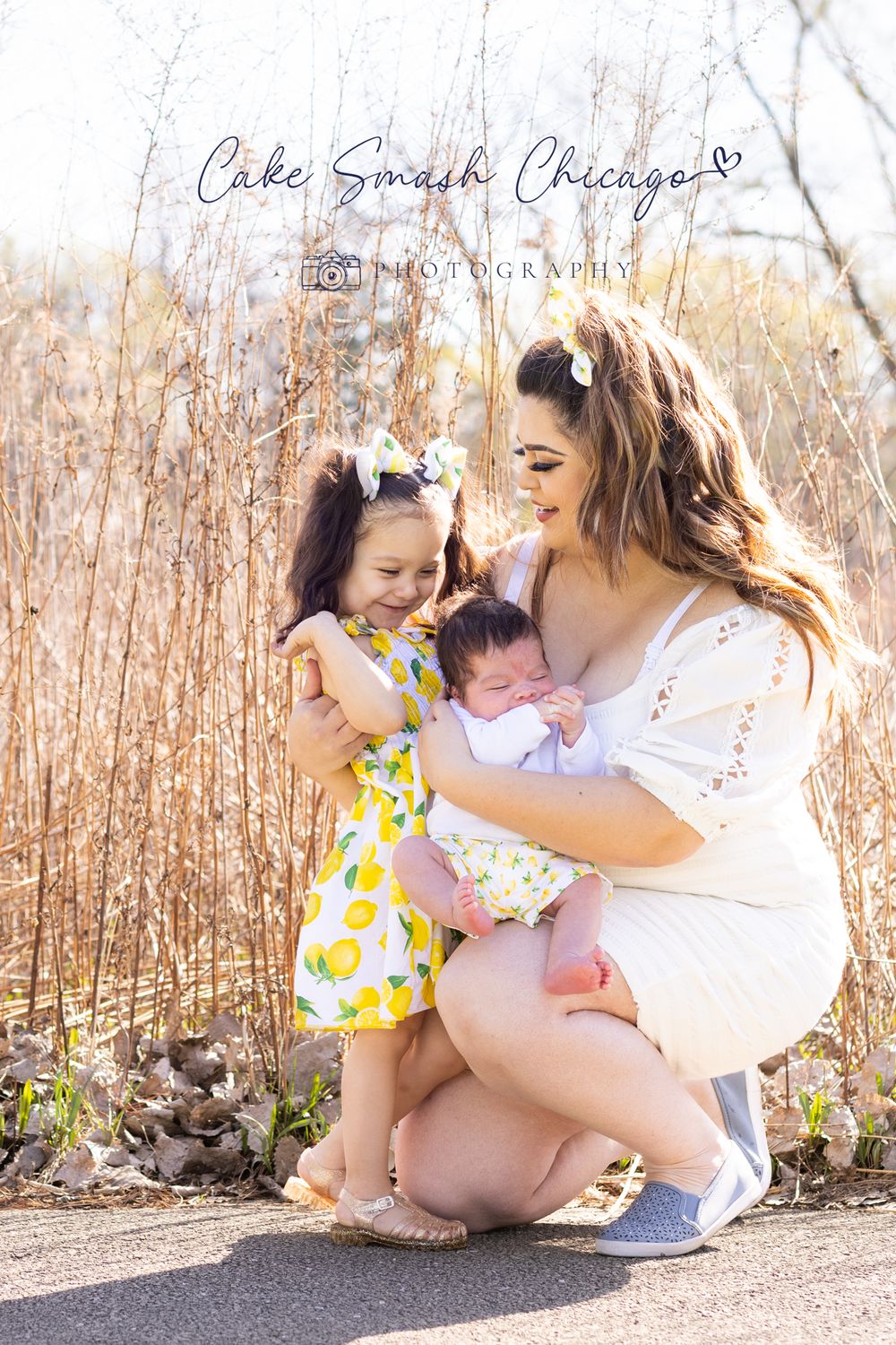 Golden hour outdoor family photography session in tall grass setting.