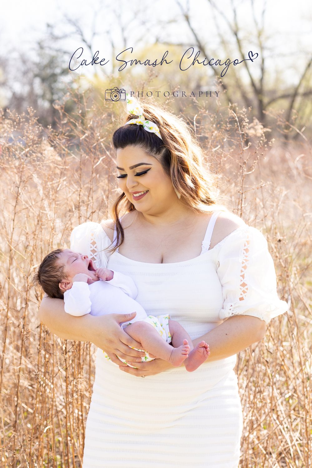 A tender moment between mother and baby captured in golden sunlight among prairie grass.