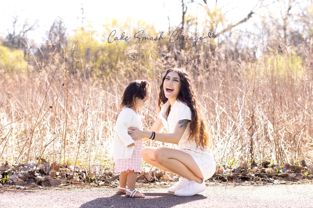 A sweet interaction between parent and child on a sunny path with golden grass in the background.
