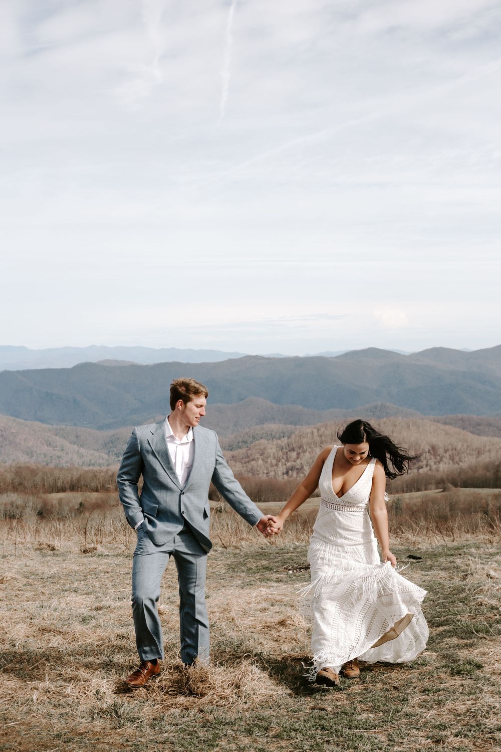 couple walking up a hill during their North Carolina elopement