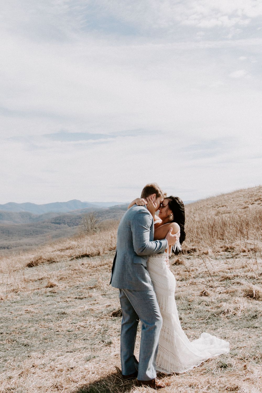 couple embracing on a mountain side during their smoky mountains elopement