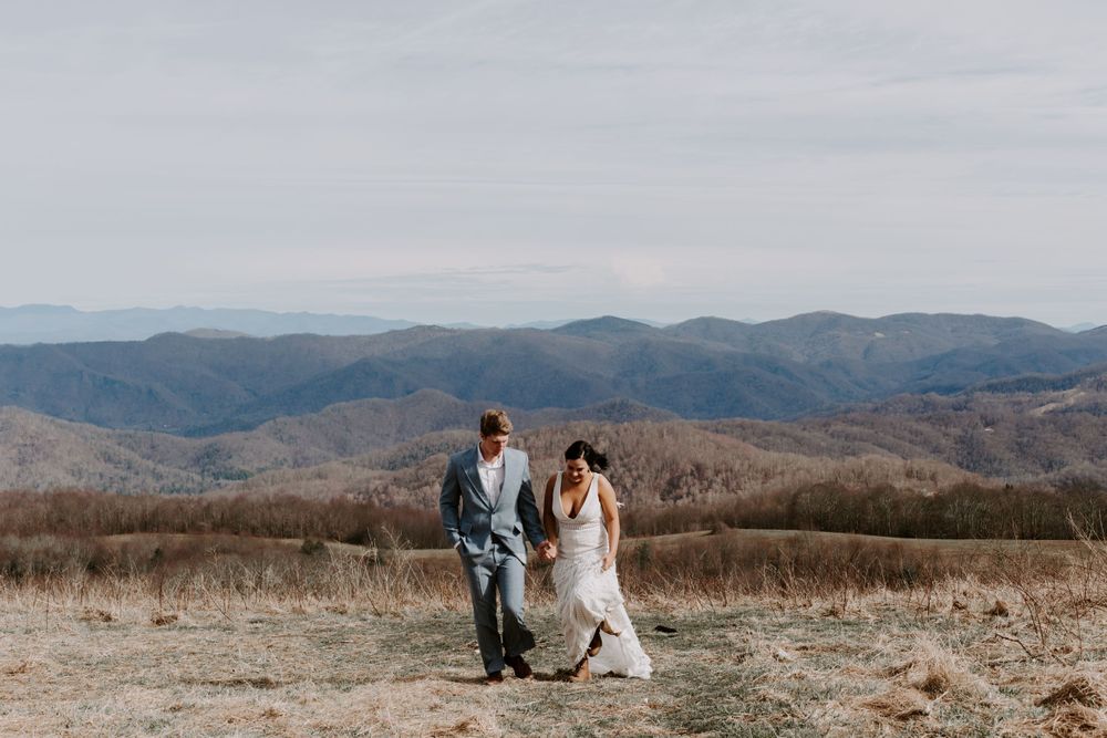 bride and groom walking up the side of a mountain during their North Carolina elopement