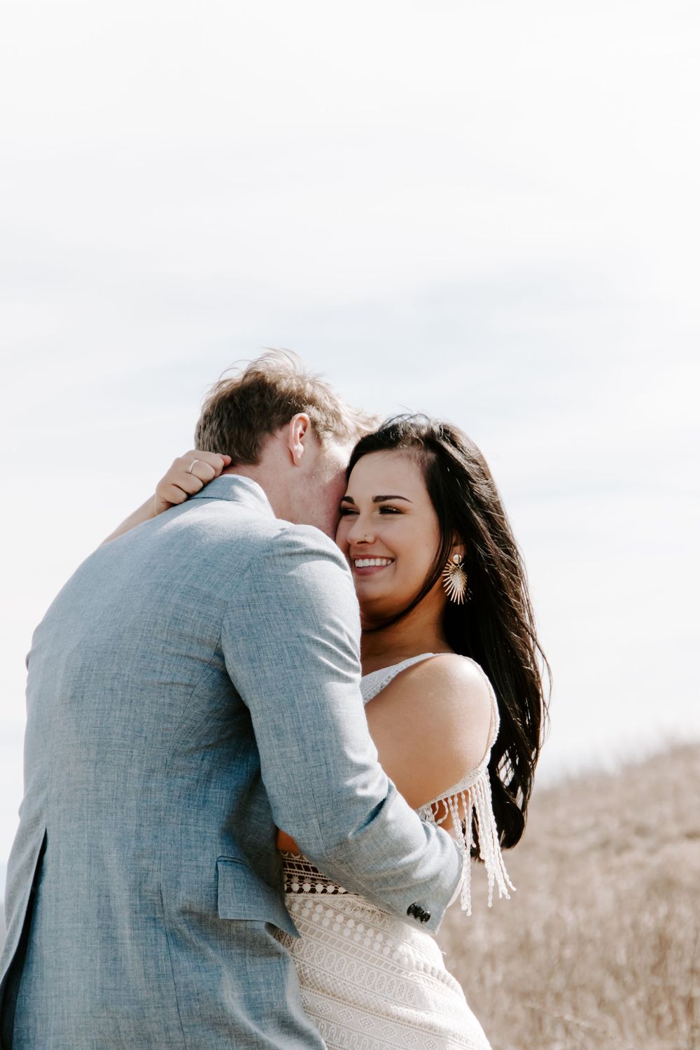 woman laughing as a man whispers in her ear during their North Carolina elopement