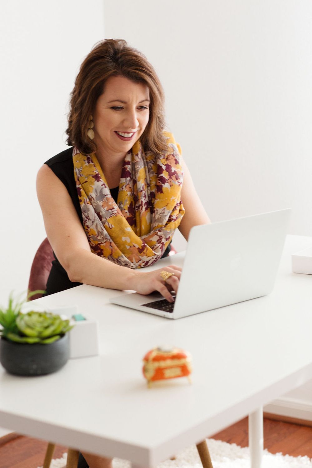 Personal brand photography for virtual assistant in white office