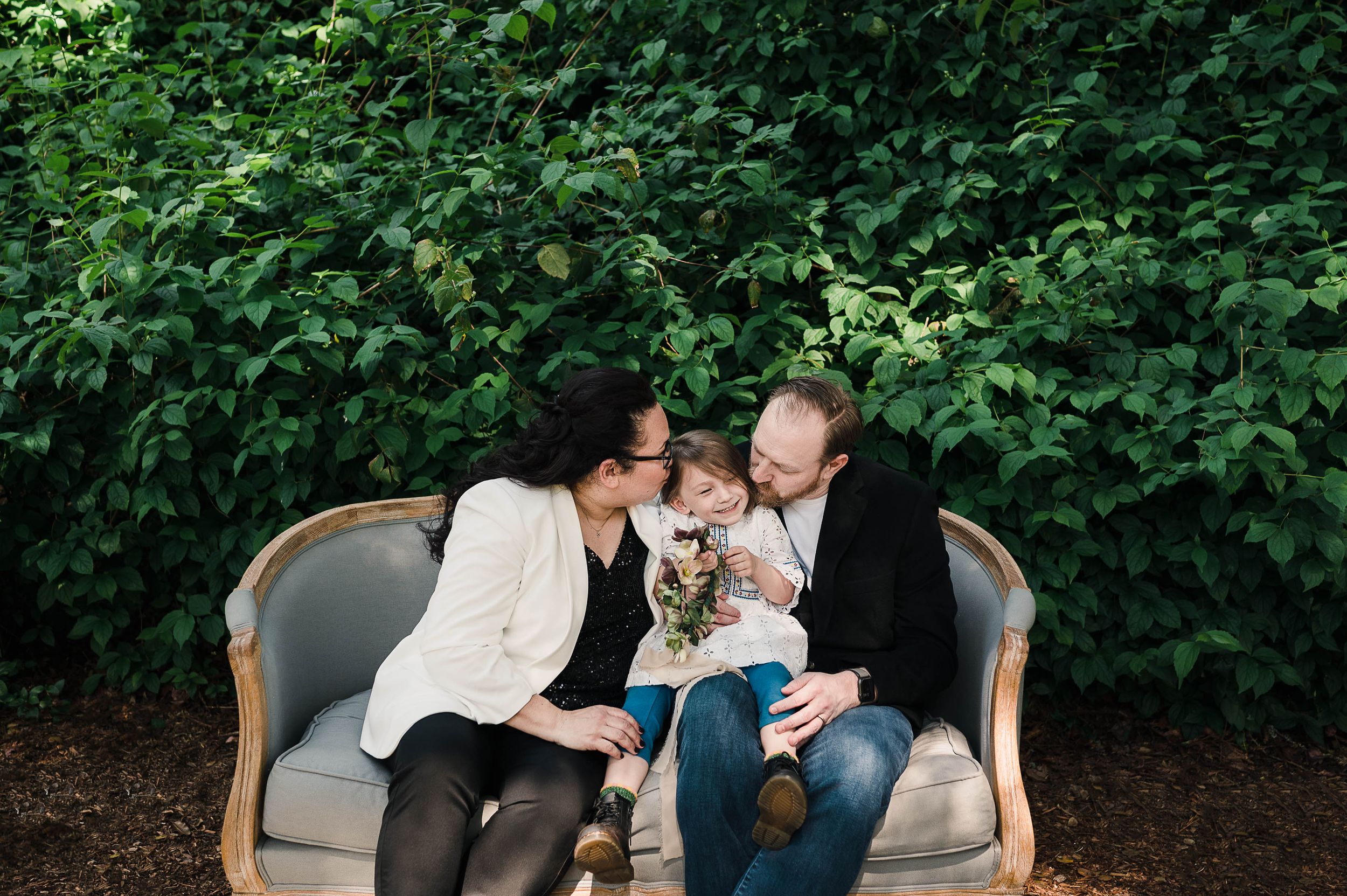 Scott and Liz giving Reagan int he middle a kiss on each cheek.