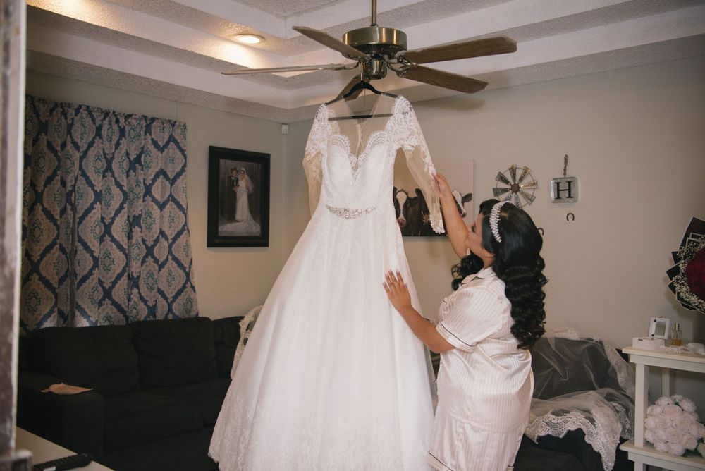 Bright looking at her dress before getting married McAllen wedding photographer