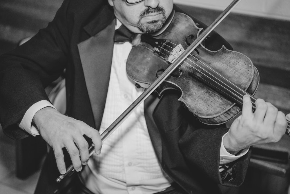 Violin playing music for the bride and groom entrance at the church. McAllen photography