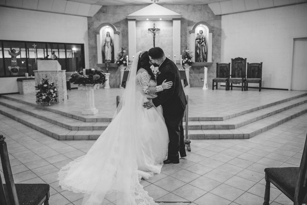 Bride and groom kissing before leaving the church. Mcallen photographer