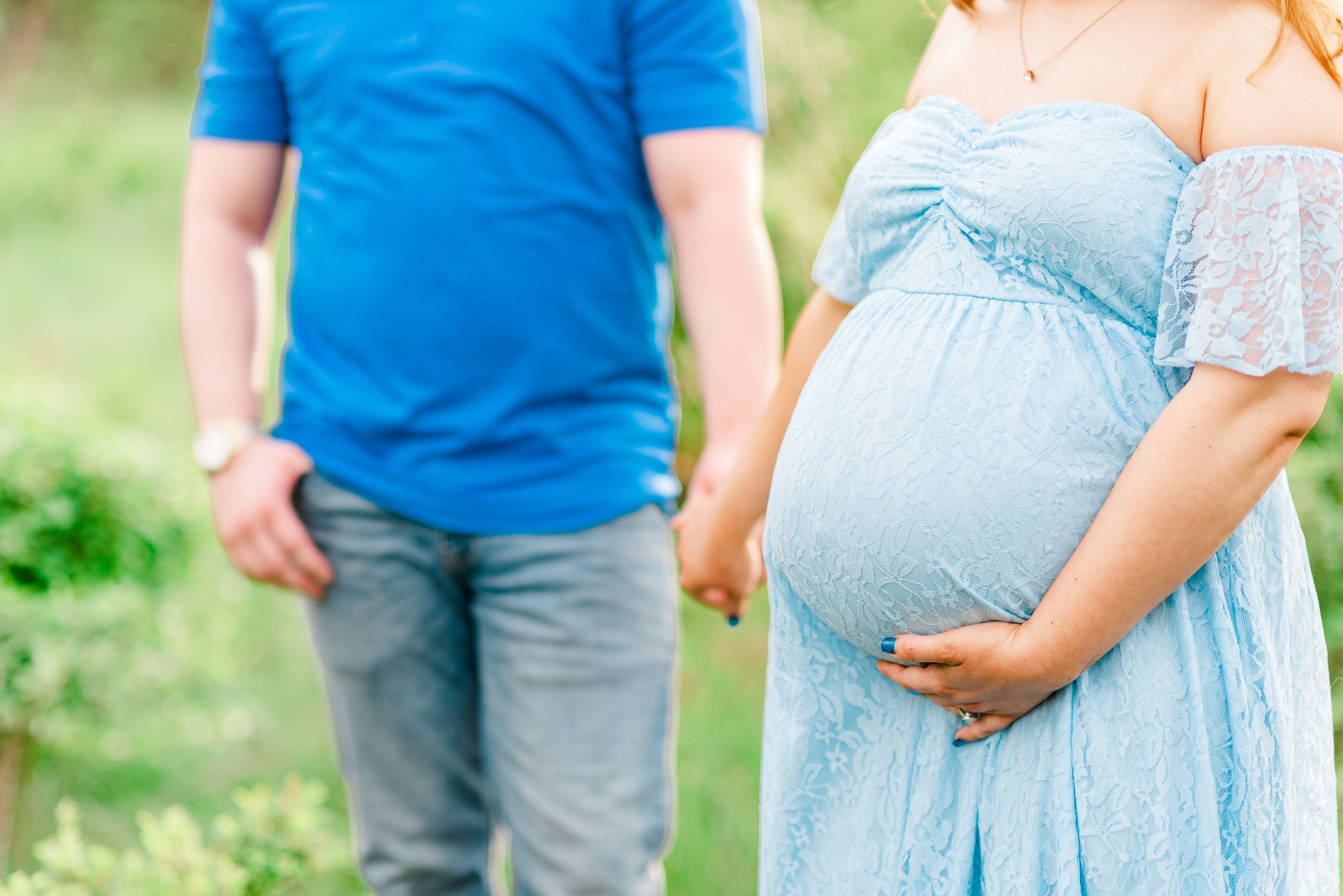 Maternity session with couple in field in golden hour sunlight at Moraine State Park, Pennsylvania