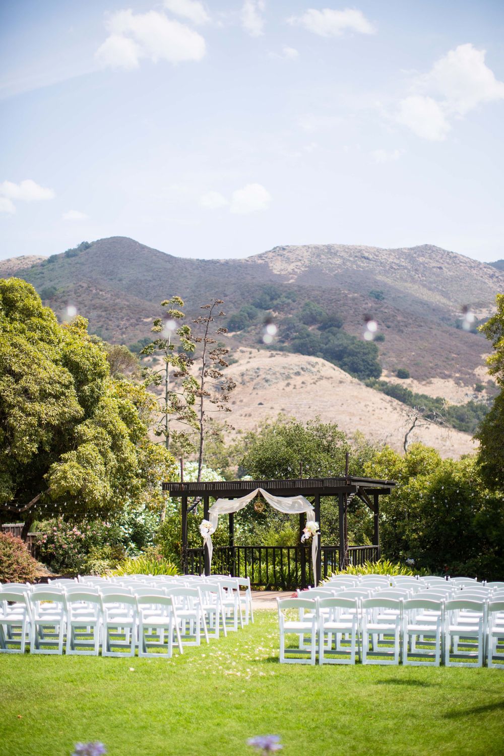 ceremony site with white chairs facing hills at Monday Club in San Luis Obispo