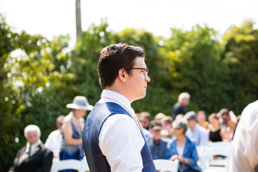 groom looking at bride walking down the aisle at Monday Club in San Luis Obispo
