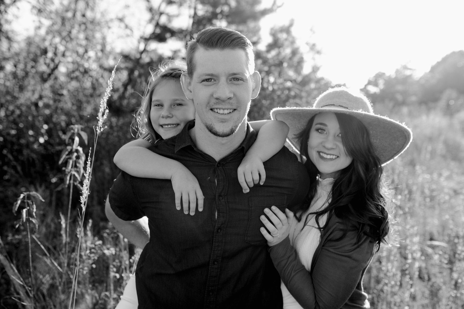 Blog Engagement Family Kansas City Photography Mom & Fiance smiling close together with mom's daughter piggybacking