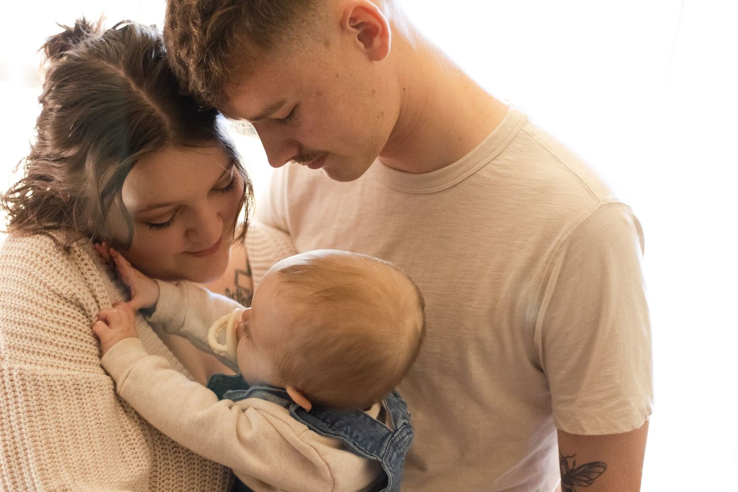 Mom and dad looking at their toddler