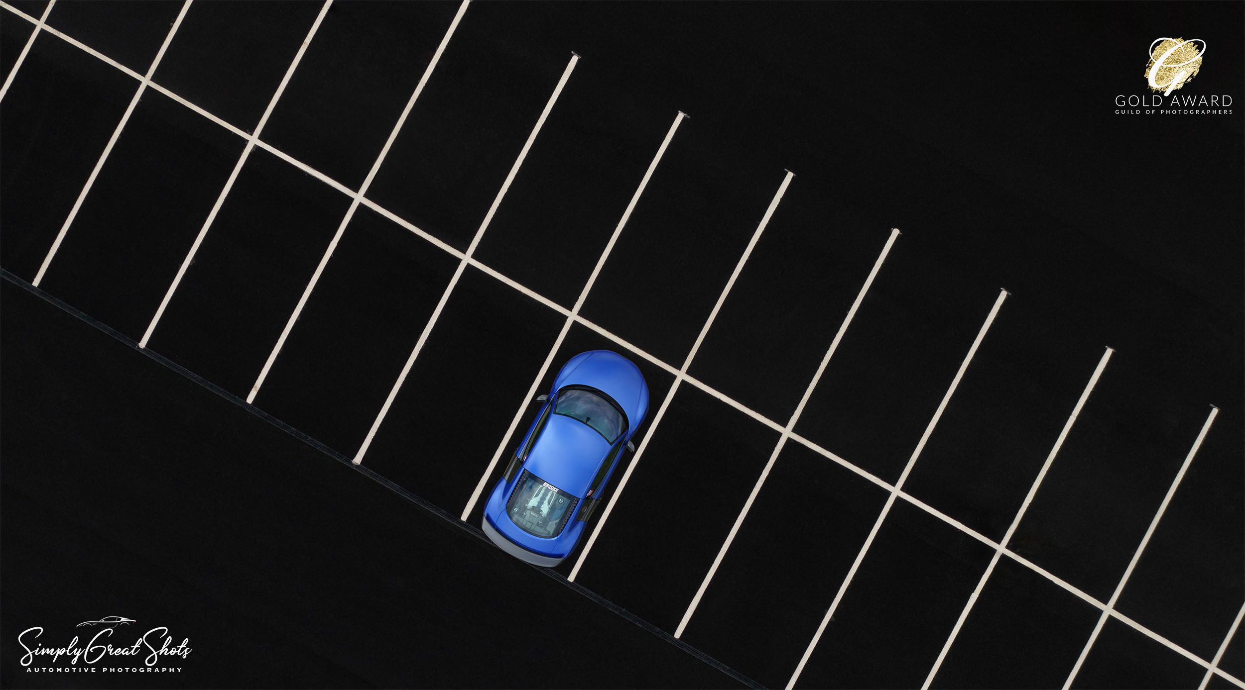Aerial Photograph of a Blue Audi R8 parked in an empty car park