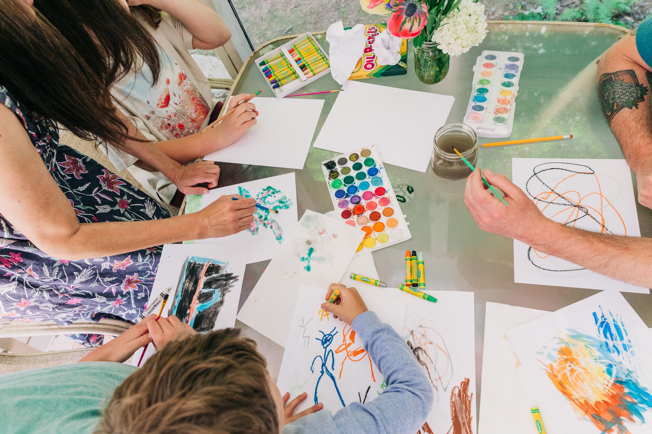 Above head shot of a family painting and drawing in their Charlotte NC home