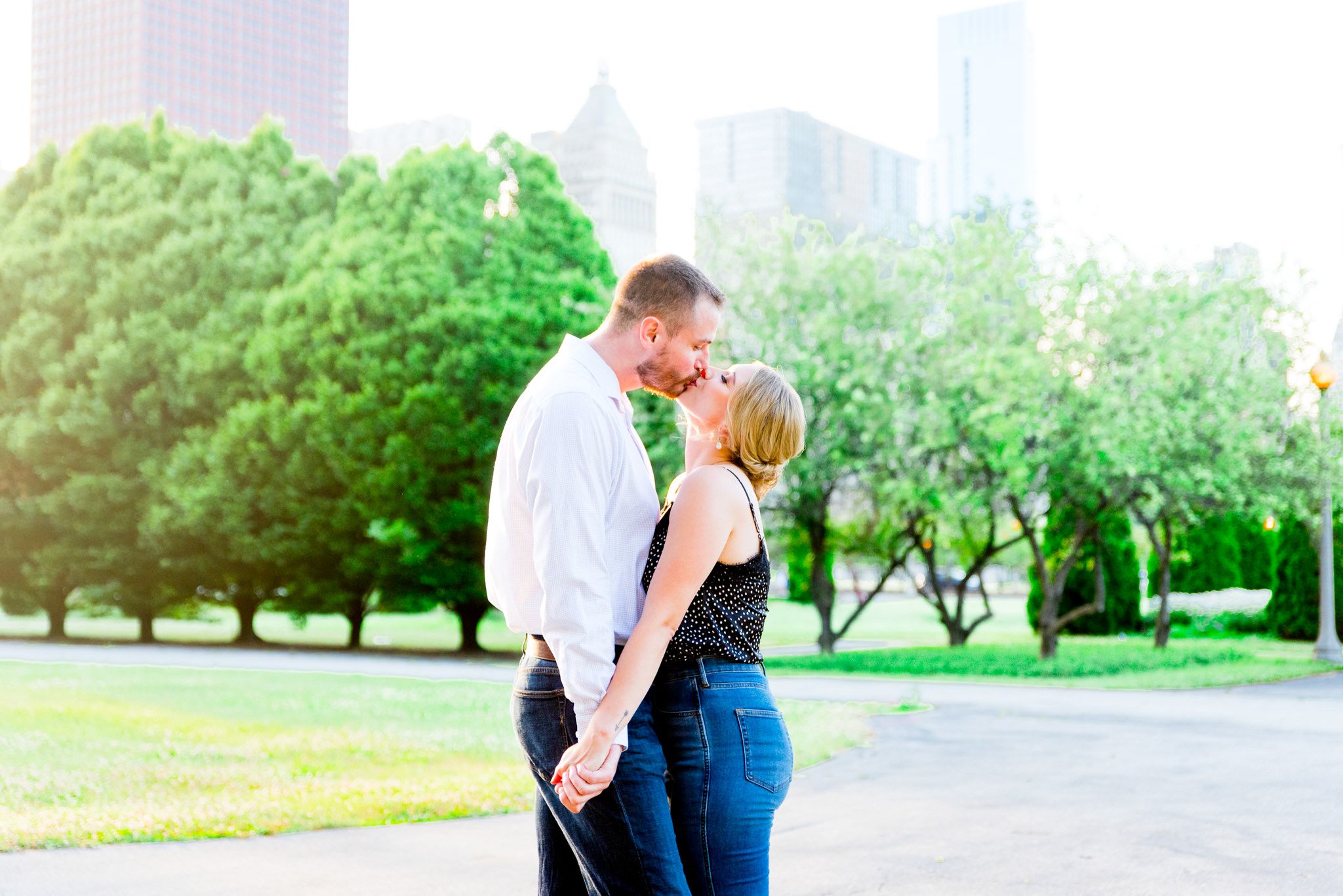 engaged man and woman kiss at sunset in Grant Park Chicago engagement pictures