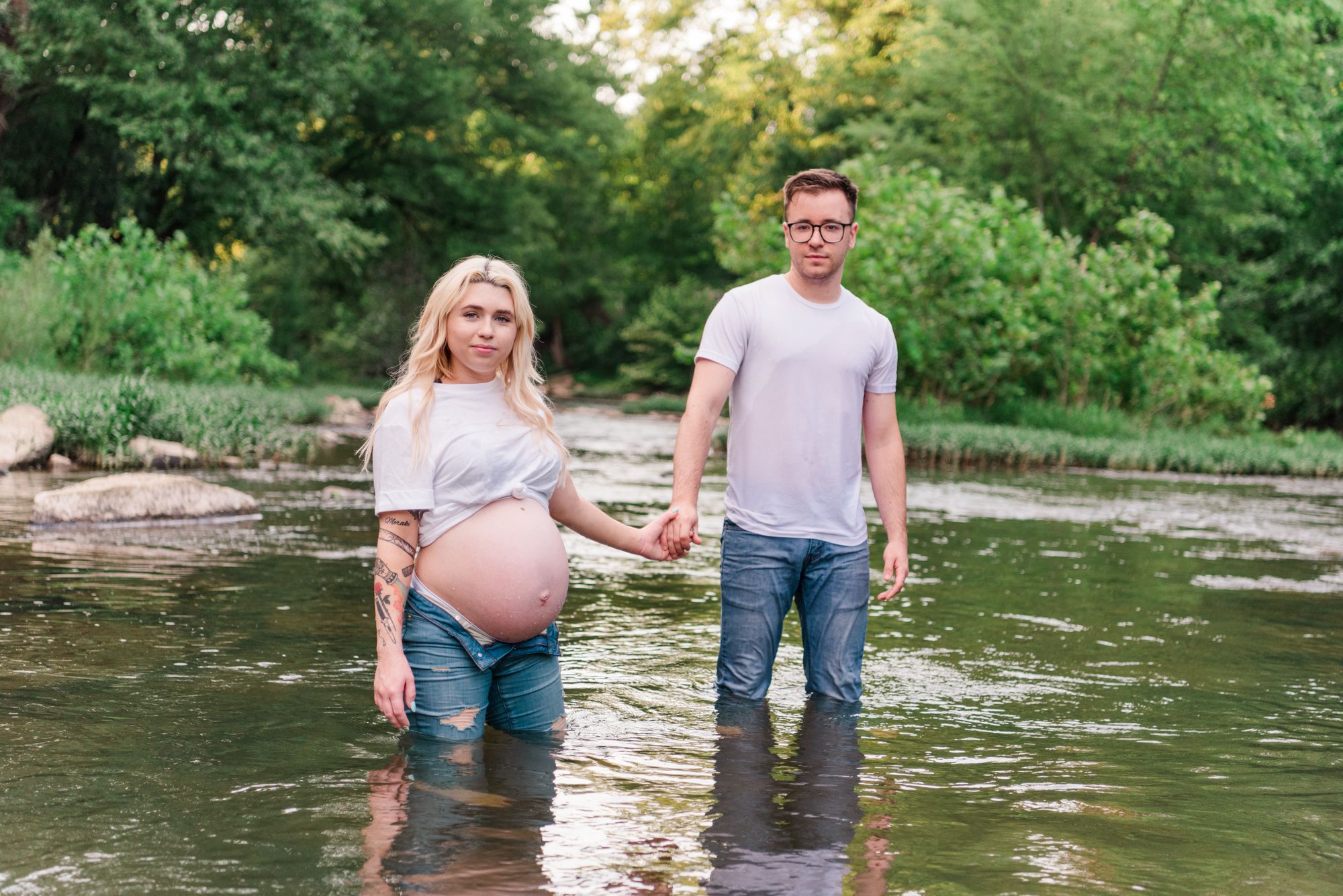 Casual maternity photos in jeans and white shirt in stream in Zelienople, Pennsylvania