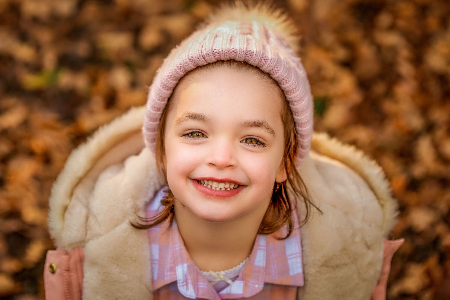 Portrait of girl in a beanie with Autumn leaves by Kate Cashin Photography.