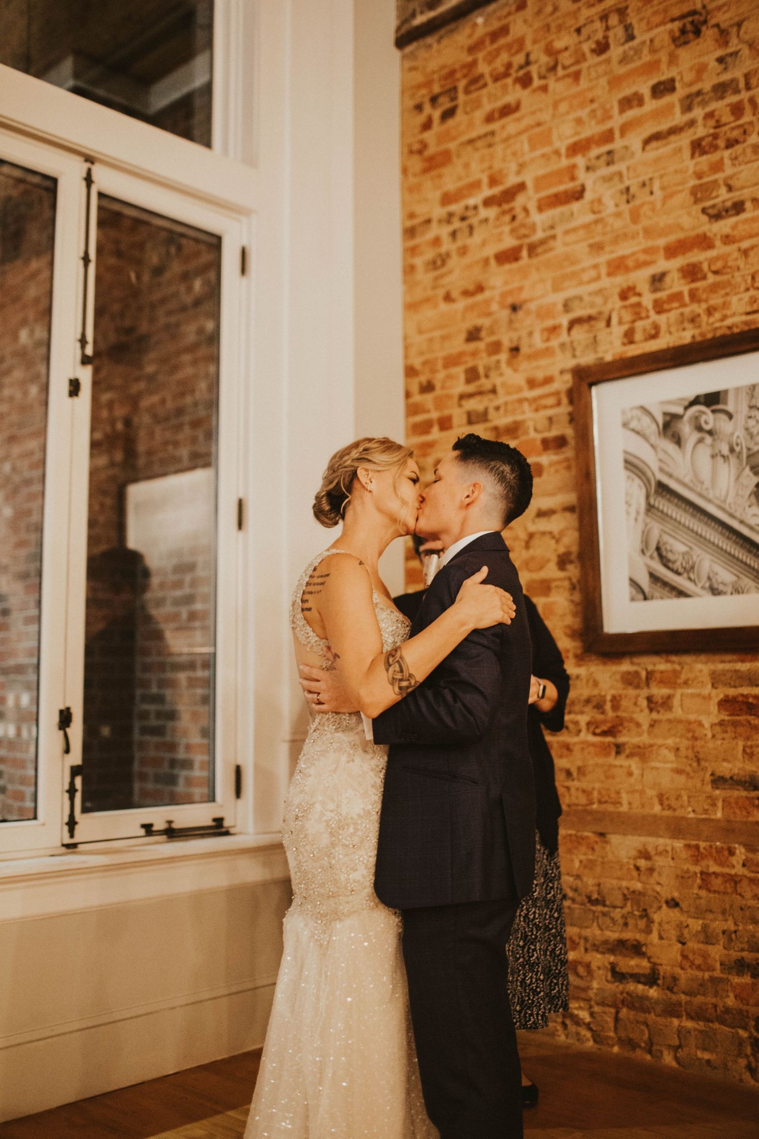 Couple kissing at wedding ceremony at Uptown Brewery in Greenville, North Carolina. LGBT Wedding.