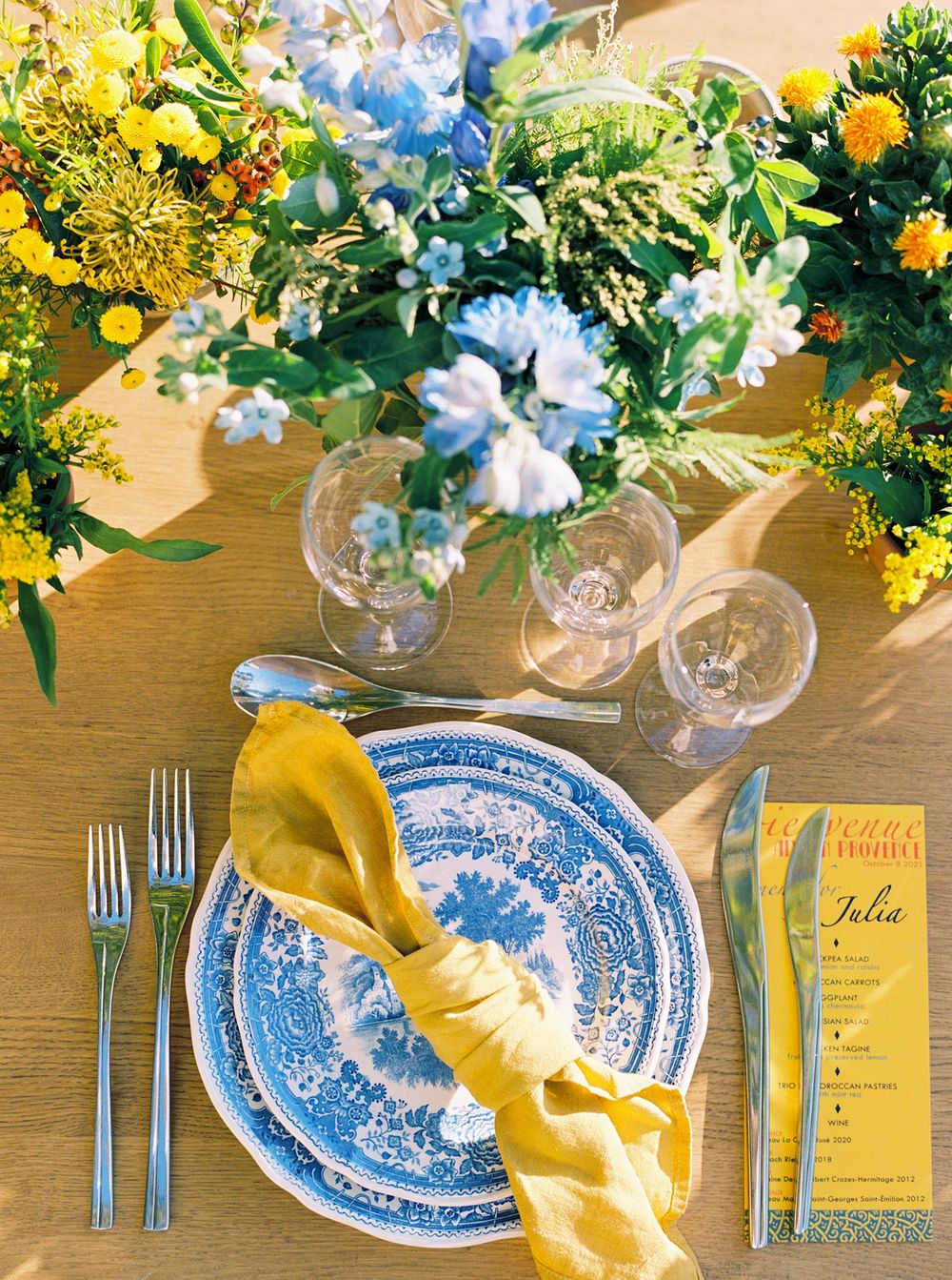 A table with a blue and white plate set for a welcome dinner at La Bastide de Ganay, Provence.