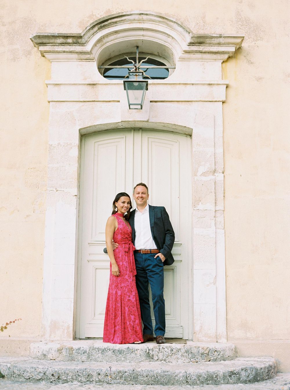 Newlyweds capturing a moment in front of a door at La Bastide de Ganay, Provence.