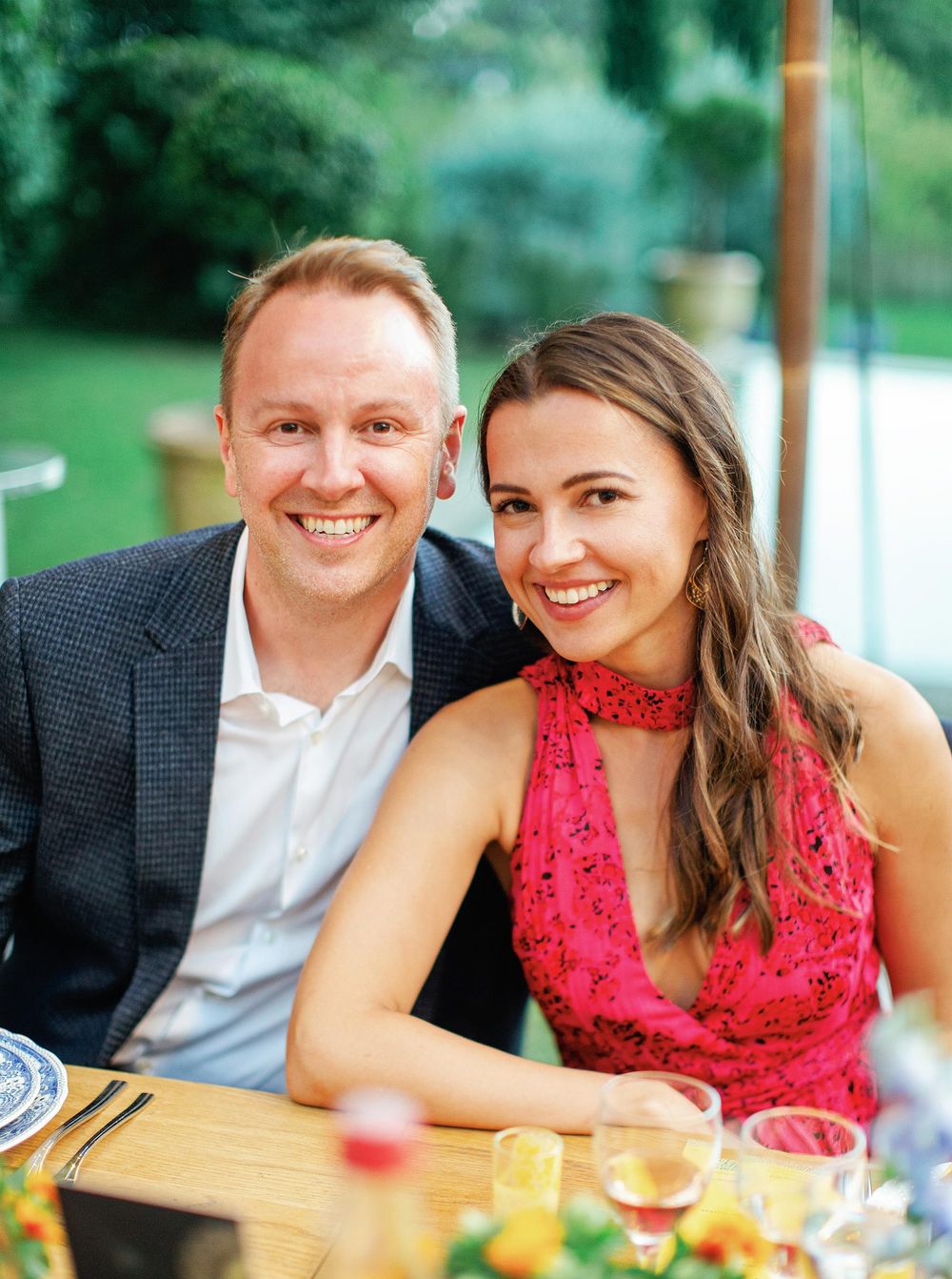A bride and groom sitting at a table, sharing a moment of togetherness on their special day.