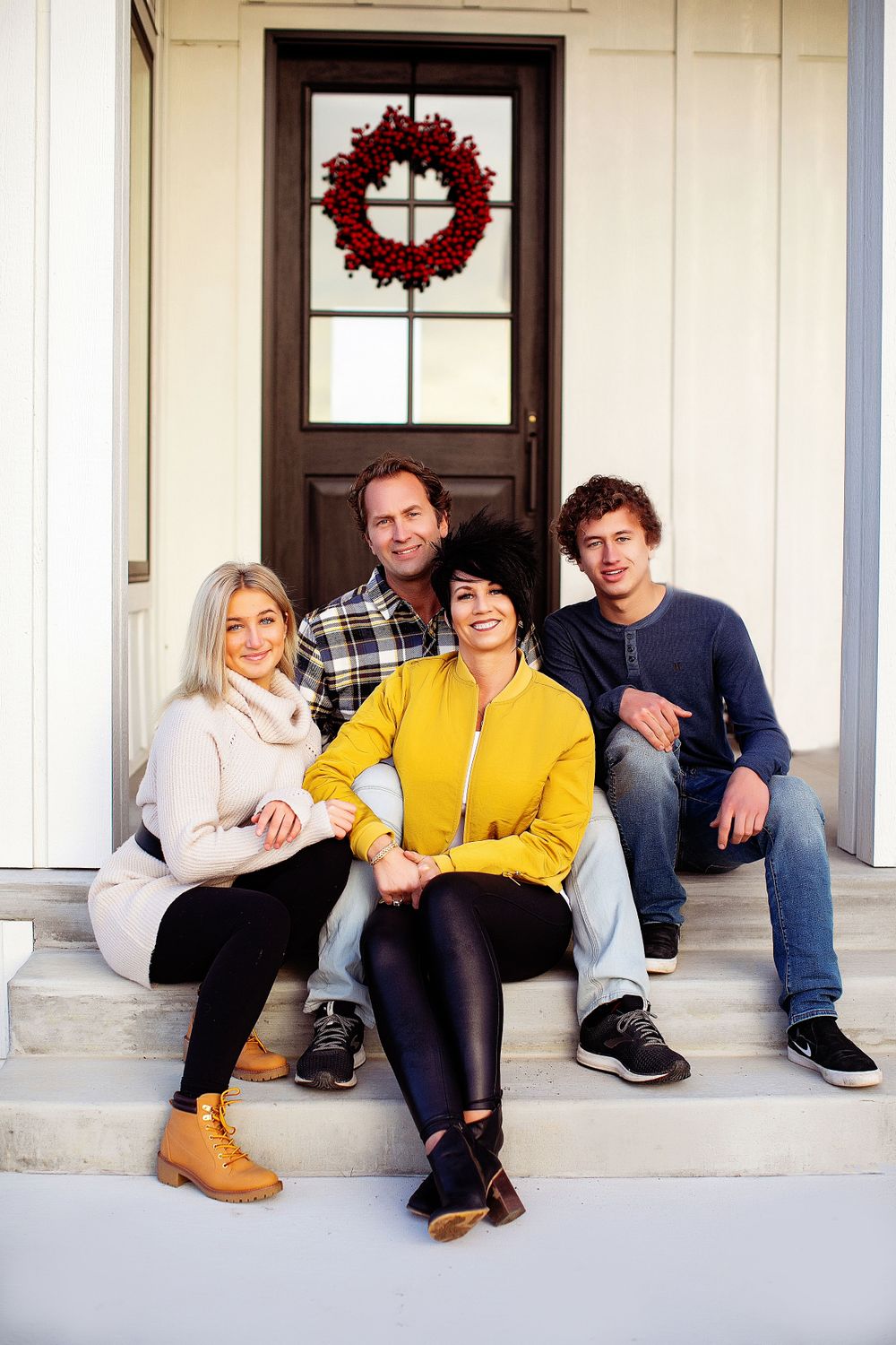 Family with older children sitting on their front porch for a Minnesota family photo session
