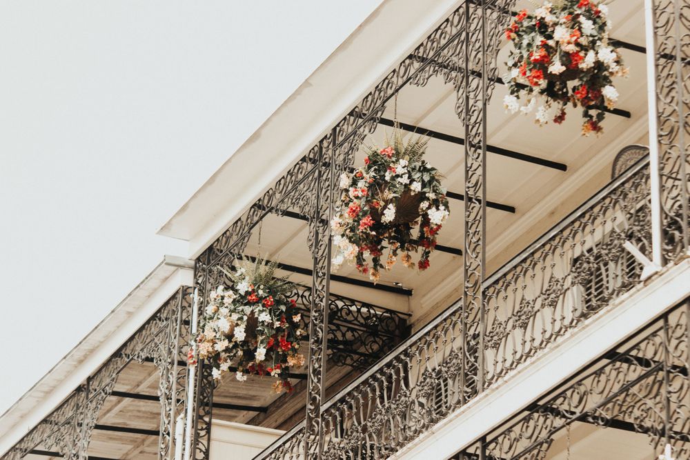 floral arrangements hanging from a second story balcony in New Orleans