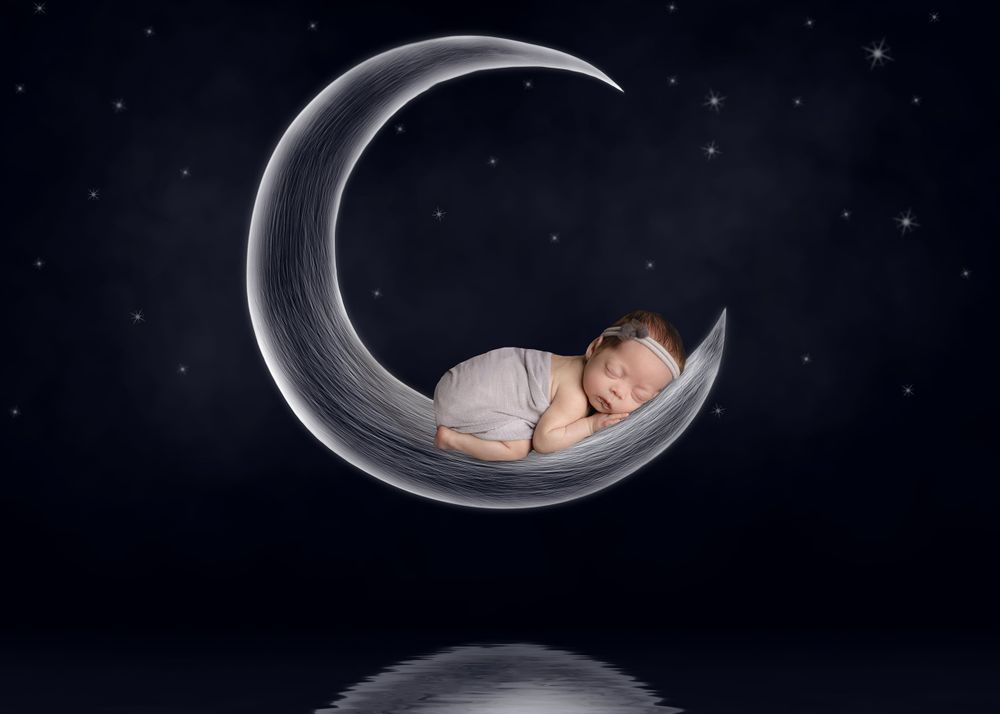 Creative baby studio baby on hand-drawn moon created by austin newborn photography studios
