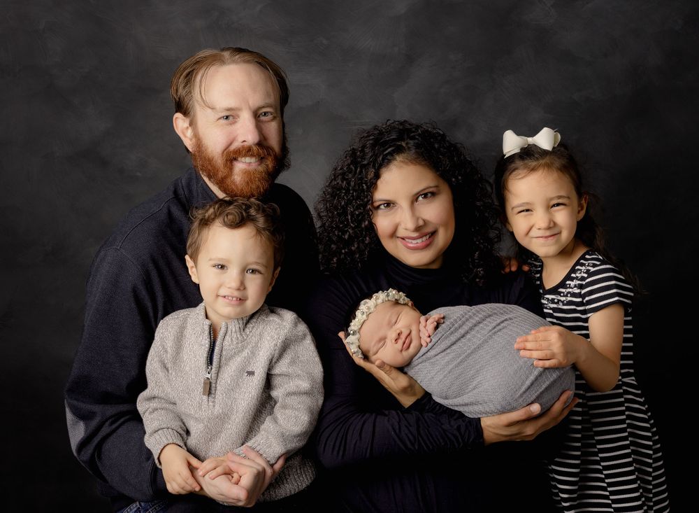 Family Portrait at austin newborn photography newborn studio with all members smiling