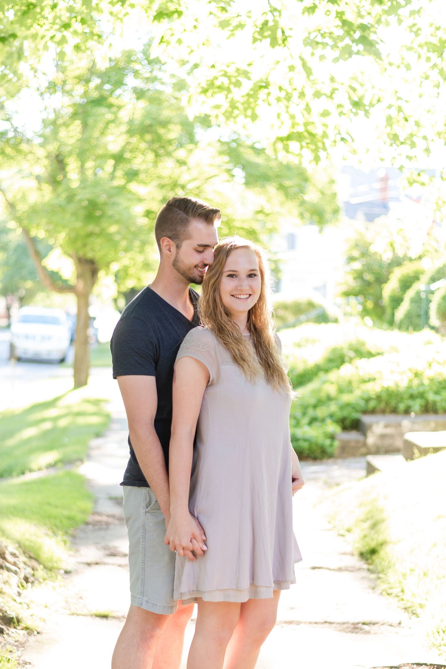 Couple standing on sidewalk for engagement in Franklin Pennsylvania