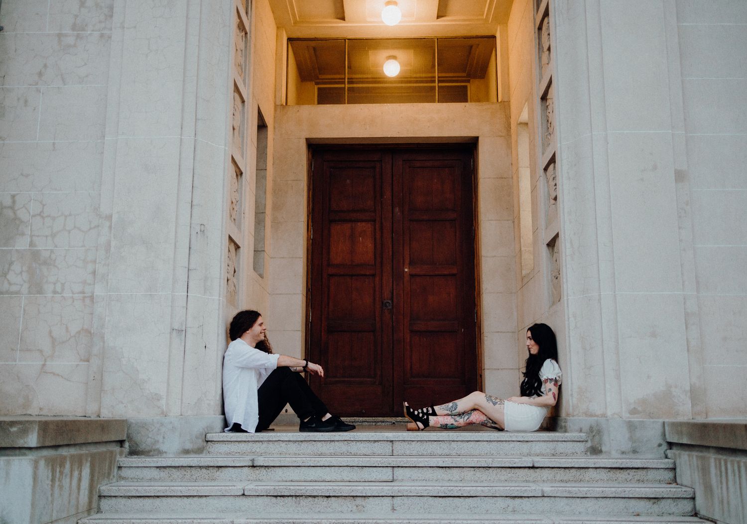 Couple sitting during their engagement shoot in Auckland Museum with Apertured Media-Auckland Wedding Photographer