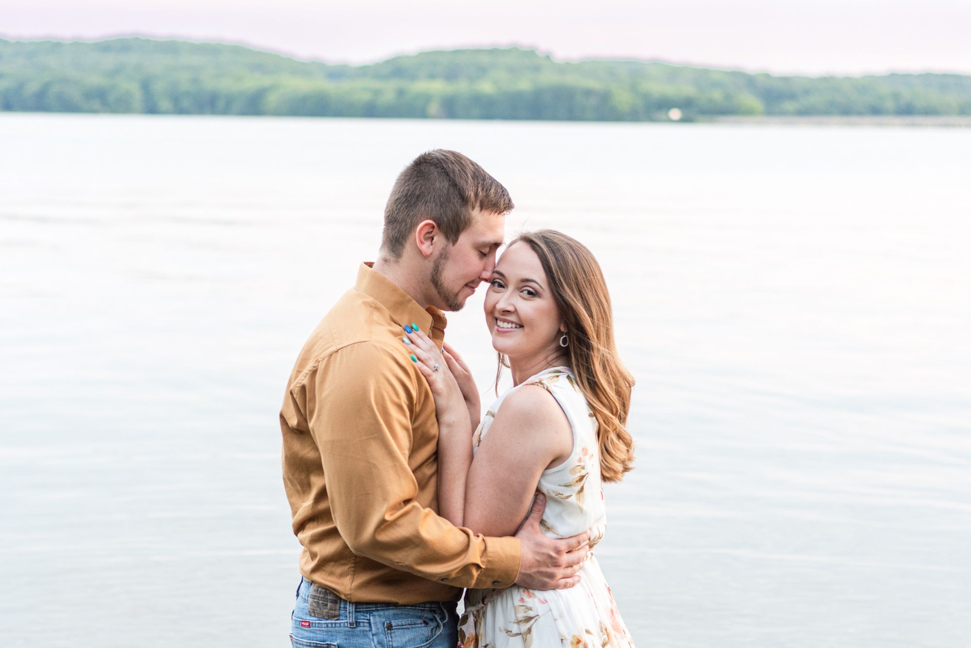 Couple holding each other in Lake Arthur for engagement at Moraine State Park in Pennsylvania