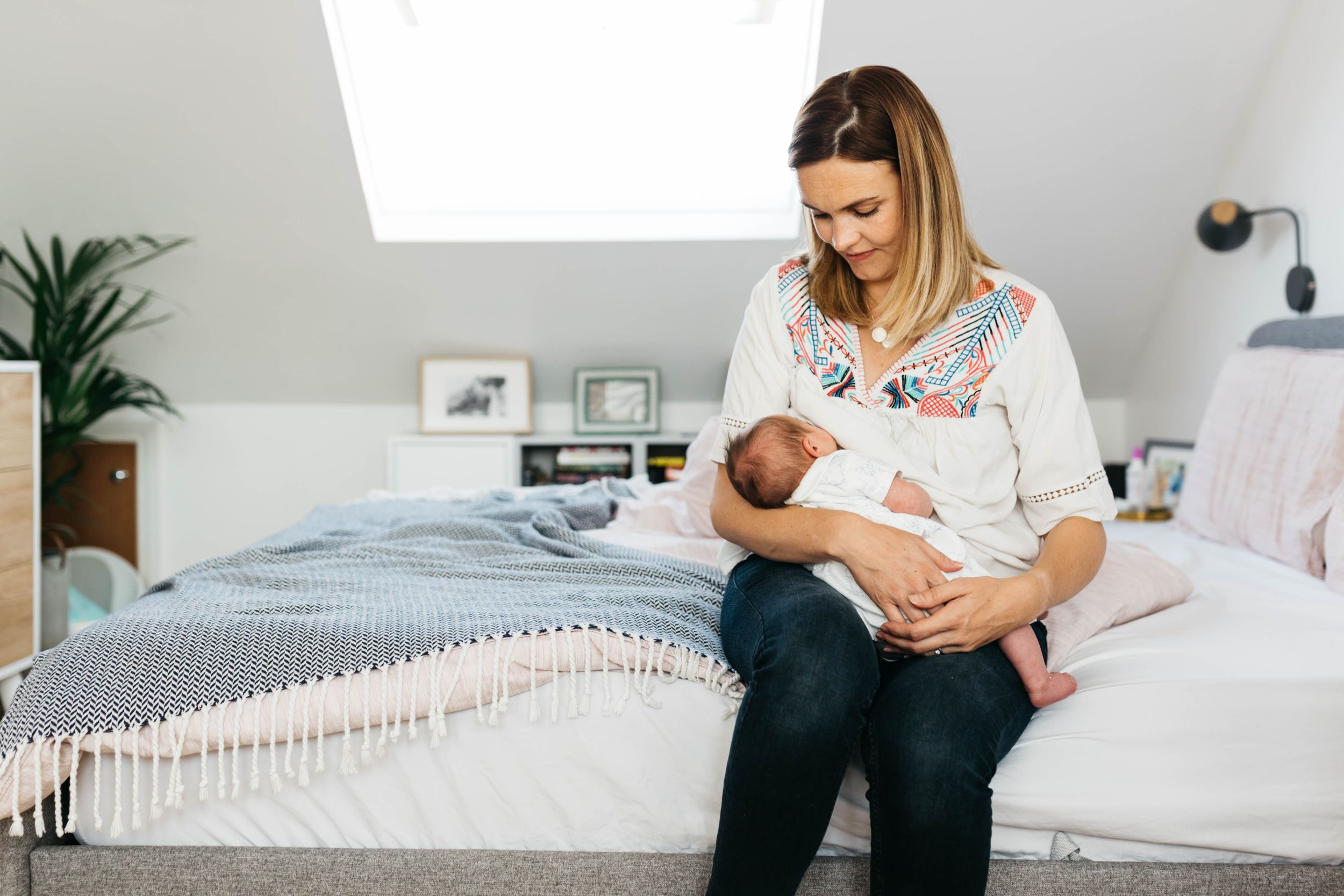 mum breastfeeding newborn baby daughter
