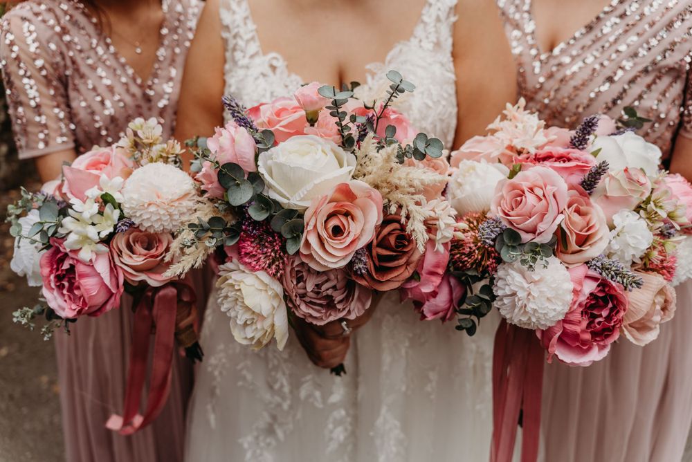 Beautiful, bright pink and white bride and bridesmaid bouquets, with a pink ribbon tied around them.